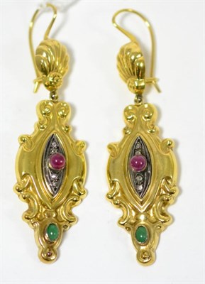Lot 271 - A pair of gem set earrings, a shell shaped drop suspends a fancy pendant, set centrally with a...