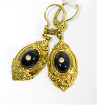 Lot 277 - A pair of onyx and diamond drop earrings, an oval cabochon onyx inset with an eight-cut diamond...