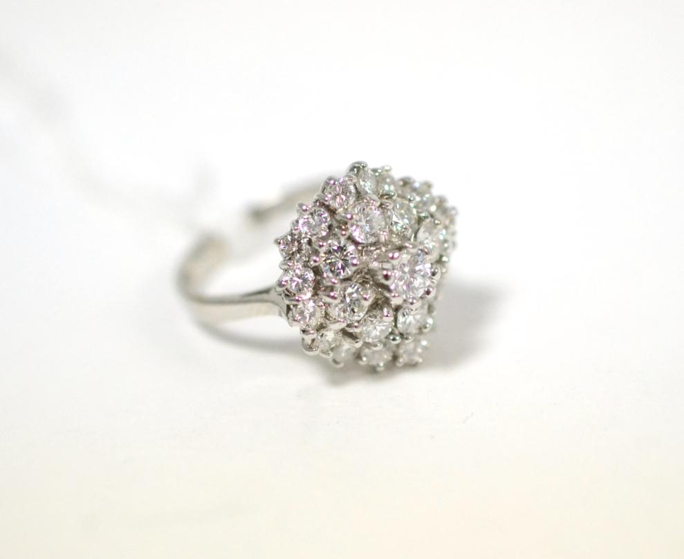 Lot 278 - An 18ct white gold undulating diamond cluster ring, round brilliant cut diamonds in claw...