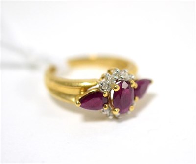 Lot 292 - A ruby and diamond ring, an oval cut ruby within a border of eight-cut diamonds and flanked by pear