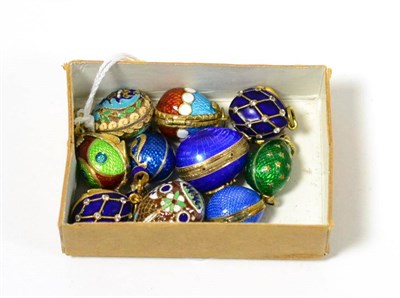 Lot 295 - Ten egg charms, enamelled in assorted colours, some hinged to open