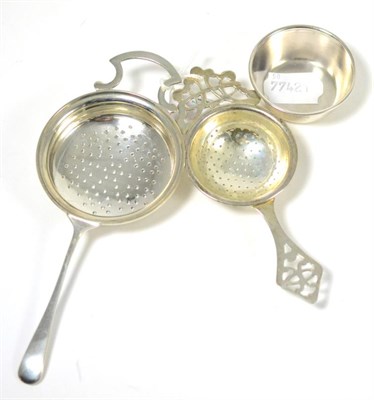 Lot 297 - ^Two silver tea strainers, Birmingham 1987 (with stand) and Birmingham, 1934
