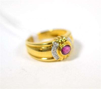 Lot 302 - A ruby and diamond ring, an oval cut ruby in a yellow rubbed over setting, flanked by bands of...