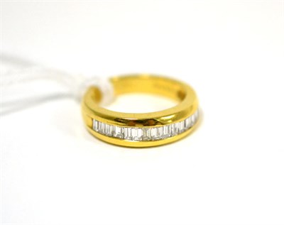 Lot 309 - A diamond half hoop ring, baguette cut diamonds in a yellow channel setting, finger size K