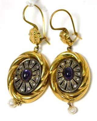 Lot 311 - A pair of amethyst set earrings, a yellow floral motif suspends a yellow rope pattern frame...