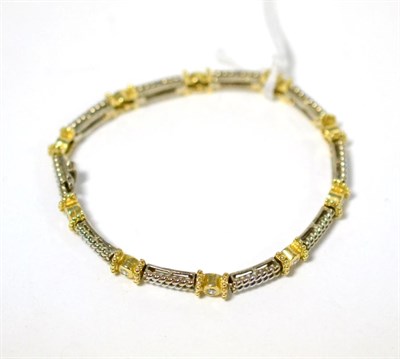 Lot 325 - A diamond bracelet, round brilliant cut diamonds in yellow rubbed over settings, to white twist...