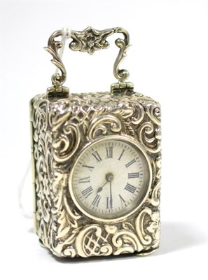 Lot 333 - A silver miniature timepiece, 1899, repousse case with scroll decoration, carrying handle,...
