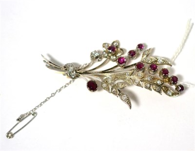 Lot 335 - A ruby and diamond floral spray brooch, set with oval and round cut rubies and old cut...