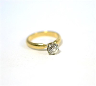 Lot 340 - A diamond solitaire ring, a round brilliant cut diamond in a white six claw setting, to a...