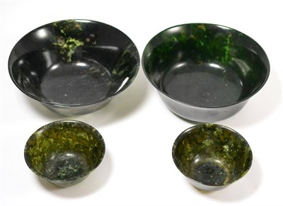 Lot 342 - A pair of Chinese spinach jade small bowls, 18cm diameter, and two larger examples, 10cm...