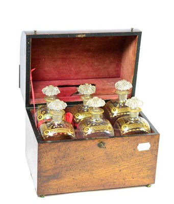 Lot 353 - A 19th century mahogany domed top decanter box, enclosing six gilt decorated decanters with...