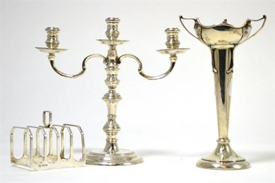 Lot 384 - An Arts & Crafts silver posy vase, with loaded base, a silver four division toast rack and a silver