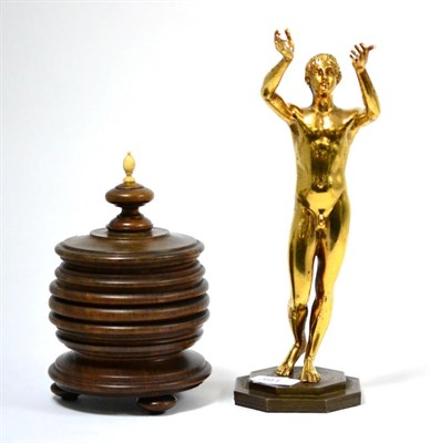 Lot 391 - A reproduction cast figure of a male nude, together with a turned walnut box and cover (2)