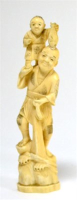 Lot 402 - A Japanese ivory okimono, early 20th century, fisherman holding a boy on his shoulders, 21cm high