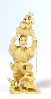 Lot 404 - A Japanese ivory okimono, early 20th century, father and son with a monkey, 12.5cm high