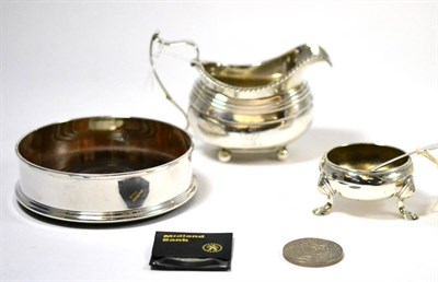 Lot 414 - ^A silver cream jug and a silver wine coaster and a silver salt, possibly Edward Wood, London, 1733