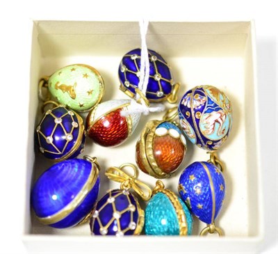 Lot 428 - Ten egg charms, enamelled in assorted colours, some hinged to open