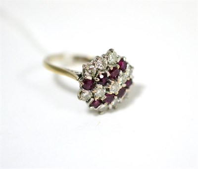 Lot 432 - An 18ct white gold ruby and diamond cluster ring, the hexagonal head set with round brilliant...