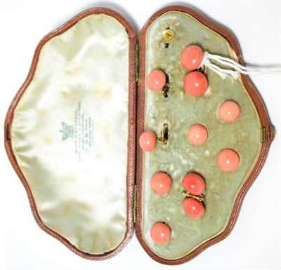 Lot 440 - A cased set of coral cufflinks and dress studs (one stud missing), the polished coral on...