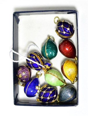 Lot 451 - Ten egg charms, enamelled in assorted colours, some hinged to open