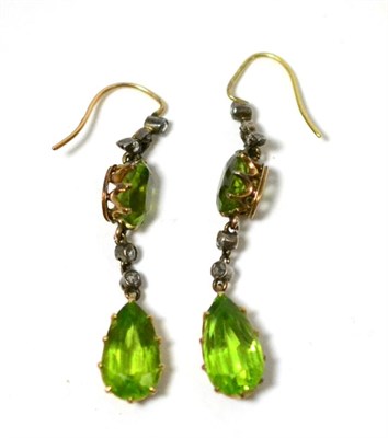 Lot 460 - A pair of peridot and diamond earrings, rose cut diamonds in white millegrain leaf settings suspend