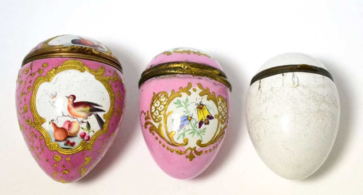 Lot 464 - An 18th century enamel egg shaped casket on a pink ground decorated with birds and fruit, a smaller