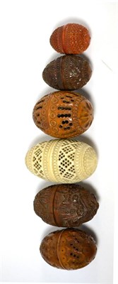 Lot 466 - Five 19th century Coquilla nut pomanders as egg caskets, together with a late 19th century bone...