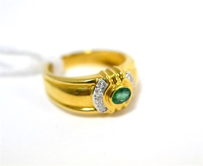 Lot 483 - An emerald and diamond ring, an oval cut emerald in yellow rubbed over setting, flanked by bands of