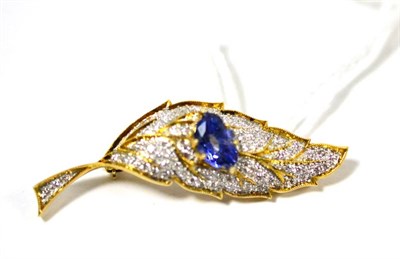 Lot 487 - A leaf brooch, with a sapphire in yellow claws centrally, pavé set diamonds around, length 4.5cm