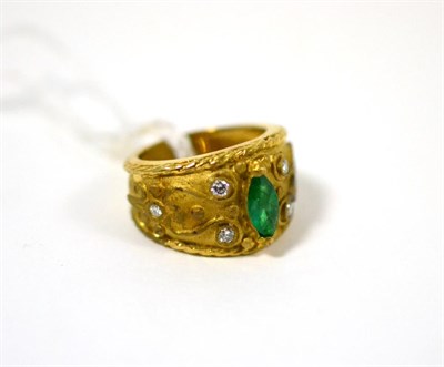 Lot 488 - An emerald and diamond ring, a marquise cut emerald in a yellow claw setting and six round...