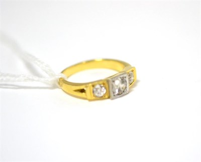 Lot 494 - A diamond three stone ring, the graduated old cut diamonds in white and yellow squared settings, on