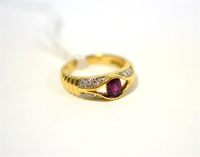 Lot 495 - A ruby and diamond ring, an oval cut ruby in yellow half rubbed over setting to an open frame,...