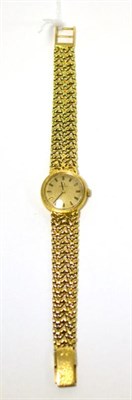 Lot 500 - A lady's 18ct gold wristwatch, signed Omega, 1972, lever movement, bark finished dial with...