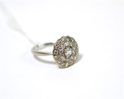 Lot 508 - A diamond cluster ring, three rows of round brilliant cut diamonds in white claw and rubbed...