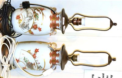 Lot 515 - A pair of Kutani porcelain baluster vases with butterfly handles, typically painted with asymmetric