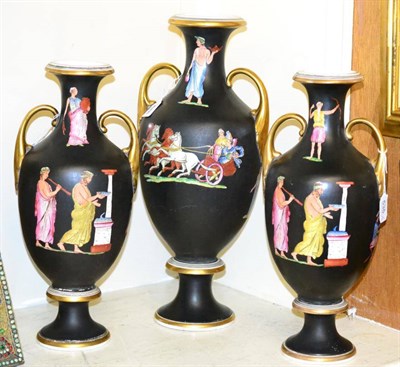 Lot 535 - A garniture of three Victorian Staffordshire porcelain twin-handled urn shaped vases decorated with