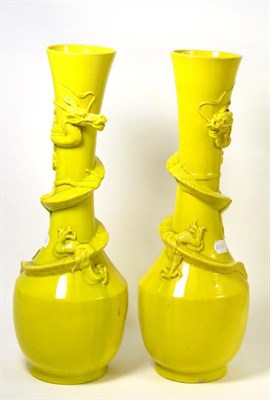 Lot 546 - A pair of large yellow ground Chinese vases with applied dragons