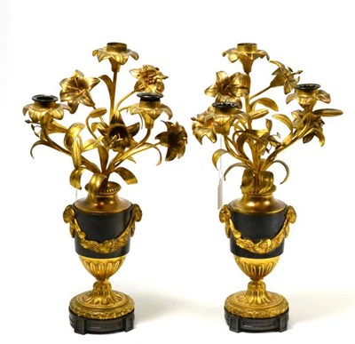 Lot 553 - A pair of ormolu candlesticks