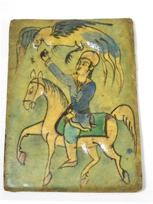 Lot 556 - A Qajar moulded tile, Persia, 19th century, depicting a hawking scene with a figure on...