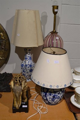 Lot 571 - A Chinese blue and white prunus decorated table lamp converted to electricity, a 20th century...