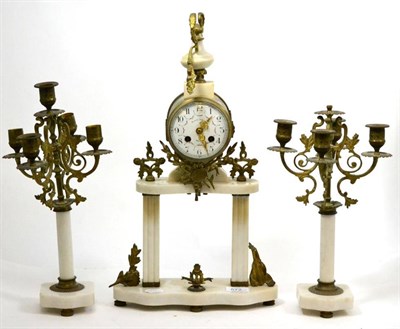 Lot 572 - A gilt metal and white marble striking mantel clock with garniture, early 20th century, portico...