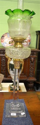 Lot 582 - A good cut glass oil lamp with green shade