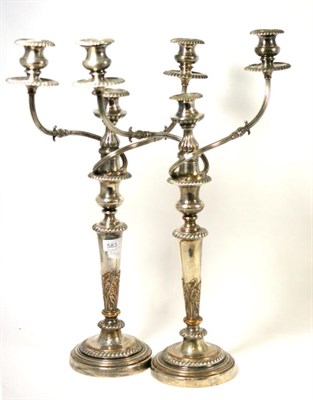 Lot 583 - A pair of plated three light candelabra