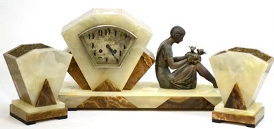 Lot 587 - An Art Deco onyx and marble striking mantel clock with garniture, signed Lamy, circa 1930,...