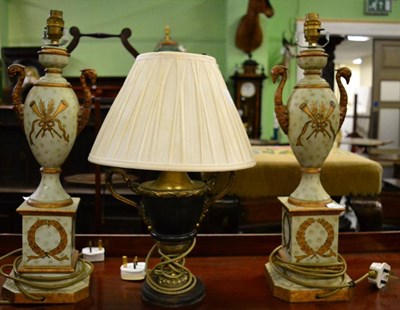 Lot 591 - A pair of green painted porcelain Campana shaped table lamps with gilt handles modelled as...