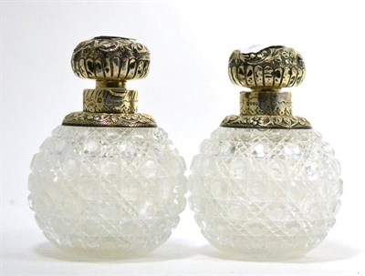 Lot 599 - A pair of Victorian silver mounted cut glass globular scent flasks and stoppers, London 1885