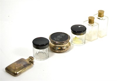 Lot 600 - Two toilet jars with 9ct gold tops, a silver hip flask, a tortoiseshell lidded silver dressing...