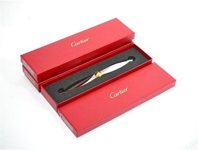 Lot 605 - Three Cartier propeller form paper knives, each cased