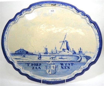 Lot 624 - A late 19th century delft blue and white wall plaque decorated with a landscape and windmills, 59cm