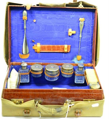 Lot 649 - Asprey crocodile travelling case and contents containing silver toilet jars and dressing table...